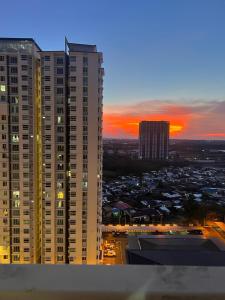 a view of a city with tall buildings at sunset at Sandakan Homestay & Backpackers in Sandakan
