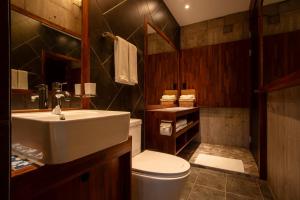 a bathroom with a white sink and a toilet at Ceylon Jeju Pool Villa in Jeju +13 photos