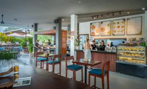 a woman standing at a counter in a restaurant at Onederz Siem Reap in Siem Reap +37 photos