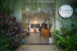 a lobby of a store with plants at Onederz Siem Reap in Siem Reap