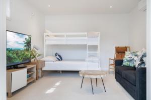 a living room with a bunk bed and a couch at The Hideaway - Coastal Chic Living in Blairgowrie