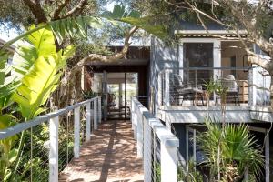 a house with a boardwalk leading to the front porch at The Hideaway - Coastal Chic Living in Blairgowrie
