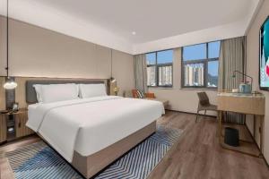 Krevet ili kreveti u jedinici u okviru objekta Echarm Hotel Changsha Electric Power Vocational and Technical College Hyde Park Branch