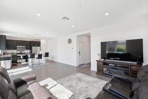 a living room with a couch and a large television at Spacious 3BR Home with Charming Backyard home in Folsom
