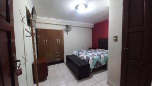 a bedroom with a bed and a dresser at Hostal 15 de Abril in Tarija