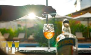 a drink in a glass on a table next to a bottle at Onederz Siem Reap in Siem Reap
