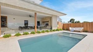 a swimming pool in the backyard of a house at Pirama - The Vintage Holiday Houses in Pokolbin