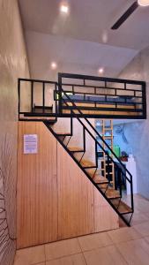 a bunk bed with a staircase in a room at El Nido Lofts in El Nido