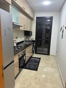 a kitchen with a sink and a stove top oven at appartement Sf in Casablanca