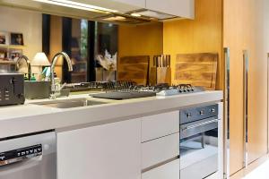 墨尔本Southside urban oasis的带水槽和炉灶的厨房