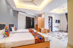 a hotel room with two beds in a room at FabHotel JP - Nr Sataragachhi Railway Station in Hāora