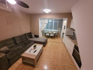 a living room with a couch and a table at Apartment Daniel in Novalja +5 photos