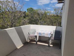 two chairs and a table on a balcony at Apartment Daniel in Novalja