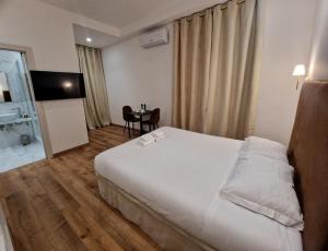 Postel nebo postele na pokoji v ubytování Cuma Suites