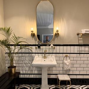 a bathroom with a sink and a mirror at Bredasdorp Square in Bredasdorp +10 photos