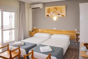 Postel nebo postele na pokoji v ubytování Hotel Alaska