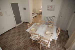 a dining room with a white table and chairs at Domus Aurea in Martina Franca +9 photos