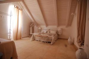 a bedroom with a large bed in a room at Domus Aurea in Martina Franca