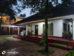a house with a car parked in front of it at MARARI SEA SCAPE HOMESTAY Beach in Mararikulam
