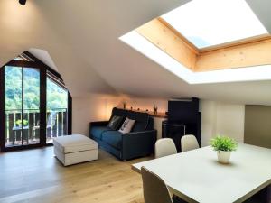 a living room with a couch and a table at Mansarda10 in Caderzone Terme