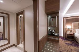 a corridor of a hotel room with a bedroom at Ramada by Wyndham Continental Jeddah in Jeddah +97 photos