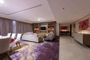 a large living room with couches and a table at Ramada by Wyndham Continental Jeddah in Jeddah