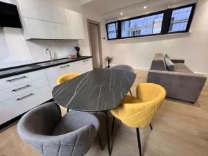 a kitchen with a table and chairs in a room at Castello Estense Luxury Apartment - Centro in Ferrara