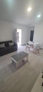 a living room with a couch and a coffee table at Casa huerta lola in Murcia