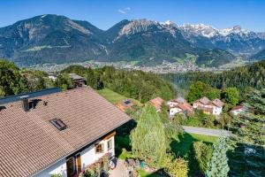 an aerial view of a house with mountains in the background at Landhaus Berthold in Bürserberg