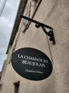 a black sign hanging on the side of a building at La Chamade en Beaujolais in Anse +10 photos