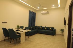 a living room with a couch and a table at Snowdrop Home Luxury 2BHK Spacious Apt in Udaipur