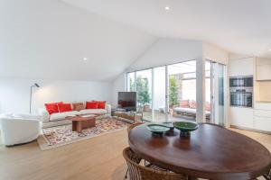 a living room with a table and a couch at Cascais Center Luxury Triplex in Cascais
