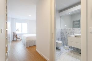 a white bathroom with a bed and a sink at Cascais Center Luxury Triplex in Cascais +24 photos