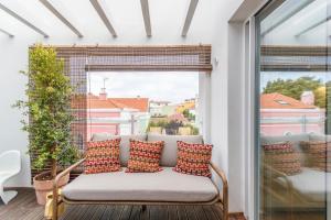 a couch on a balcony with a window at Cascais Center Luxury Triplex in Cascais