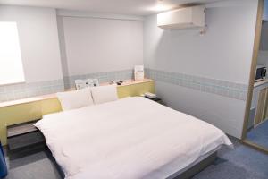 Postel nebo postele na pokoji v ubytování Hotel HERB ホテルハーブ大人用