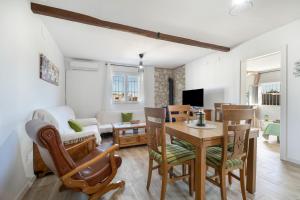 a living room with a table and chairs at Casa Rural La Ferrera Chiclana in Chiclana de la Frontera