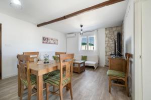 a dining room and living room with a table and chairs at Casa Rural La Ferrera Chiclana in Chiclana de la Frontera