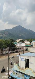 a view of a city with a mountain in the background at chendur Residency in Tiruvannāmalai