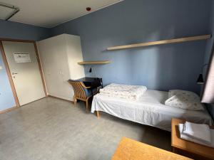 a bedroom with a bed and a desk in it at Agder Folkehøgskole - Gjestehus in Kristiansand