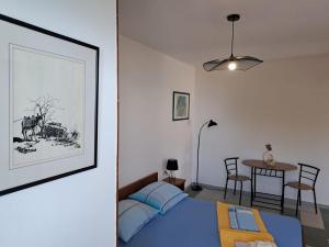 a bedroom with a bed and a table with chairs at Rooms Katja in Gradac
