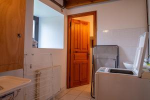 a kitchen with a sink and a refrigerator in it at Gites de france de la fage montivernoux in Saint-Laurent-de-Veyrès +26 photos
