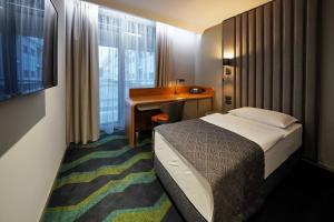 Voodi või voodid majutusasutuse HABAKUK Wellness & Event Hotel toas