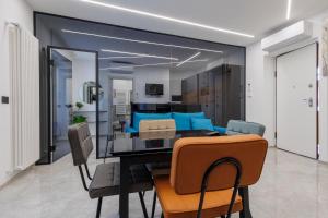 a dining room and living room with a table and chairs at La Suite Nel Borgo - Ai Piedi delle Alpi&Centro Storico in Borgo San Dalmazzo