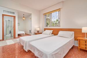 two beds in a white room with a window at Apartamento Sol de la Molina in Salobreña +30 photos