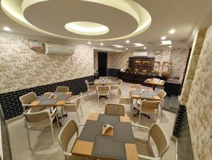 a restaurant with tables and chairs in a room at G3 Star Comfort in Chennai