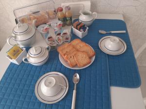 a table with a blue table cloth with bread on it at My Comfort Suite in Naples +12 photos