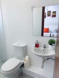 Un baño blanco con inodoro y lavabo. en Wokabi Homes, en Mombasa