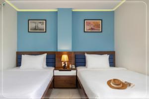 Postel nebo postele na pokoji v ubytování Ngoc Bich hotel