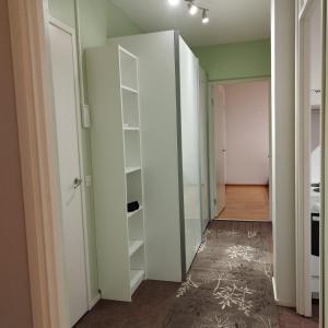 un corridoio con un armadio bianco e una stanza di Skandinavisen taiteilijan 2 h huoneisto 2 a Lahti