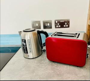 a red and silver toaster sitting on a counter at 1st 4 Tennants in Portsmouth +7 photos